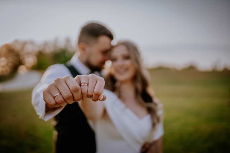 Newlywed couple showing off wedding rings